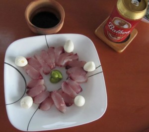 Dorado sashimi with quail egg garnish.